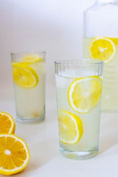 three glasses filled with lemonade and water