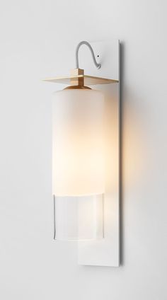 a wall light with a white shade on it