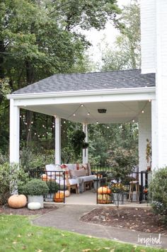 an outdoor covered patio with lots of furniture