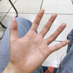 a person holding their hand up in the air