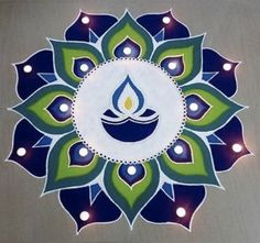 a blue and green flower with candles in the center on a gray background that says happy diwali