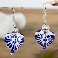 Artisan Monica Vazquez of Mexico designs these original dangle earrings using hand-painted heart-shaped ceramic beads crafted in Puebla. The Talavera-style beads are topped by sterling silver beads and feature petite blue crystal beads at the bottom. The earrings swing from sterling silver hooks. Infinite Jewelry, Ceramic Hearts, Blue Crystal Beads, Blue Clay, Pottery Handbuilding, Organic Jewelry, Ceramic Earring, Heart Dangle Earrings, Ceramics Pottery Art