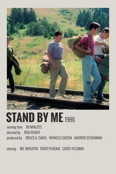 the poster for stand by me, featuring three men standing on train tracks