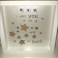 a shadow box with some stars on it and the words dad i love you to the moon and back