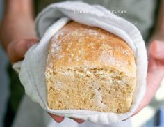 a close up of a person holding a piece of bread in their hand with a cloth over it