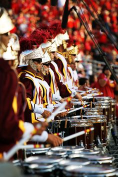 a group of people that are standing in front of some drums