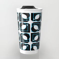 a black and white coffee cup with blue circles on it's side, in front of a gray background