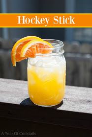 an orange drink in a mason jar with the words hockey stick written on it's side