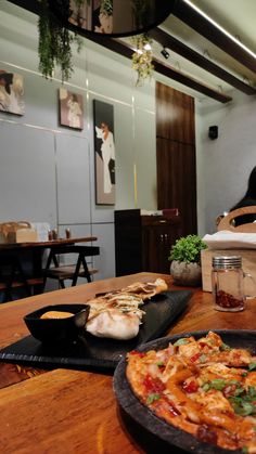 a pizza sitting on top of a wooden table