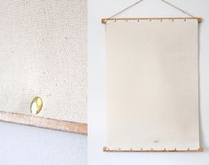 a white wall hanging next to a wooden frame