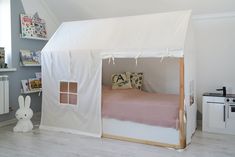 a bed with a white tent on top of it