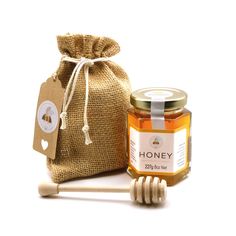 a bag of honey next to a wooden stick