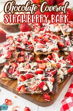 chocolate covered strawberry bark on a cutting board with strawberries