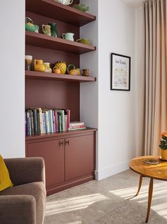 a living room filled with furniture and bookshelves