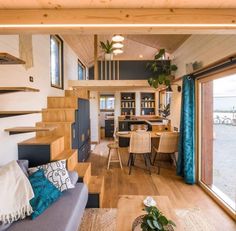 a living room filled with furniture next to a kitchen and dining area in a home