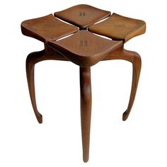 a wooden stool with four square shaped sections on the top and bottom, sitting in front of a white background