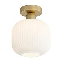 a light fixture with a white glass ball on the top and gold trimmings