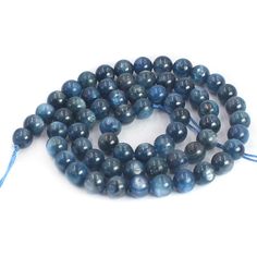 the beads are blue and have tassels on each side, with a string attached to them