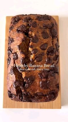 a loaf of chocolate chip banana bread on a cutting board with the words healthy banana bread