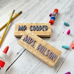 two wooden crayons with the words mr and mrs wilson on them next to colored crayons