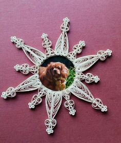 a white snowflake with a brown dog in it