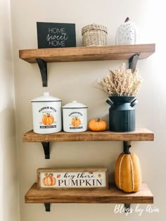 three shelves with pumpkins and other items on them