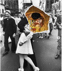 a man and woman kissing while holding an umbrella over their head on the street in front of people