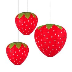 three red paper strawberries hanging from strings