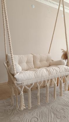 a white couch sitting on top of a wooden floor next to a rug covered floor