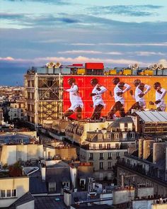 a large billboard on the side of a building with men in white shirts doing different things