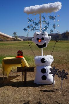 there is a snowman made out of cotton balls and other stuff on the ground