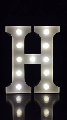 the letter h is lit up with lights