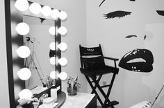 a black and white photo of a woman's face in front of a mirror