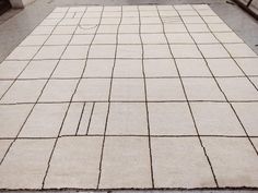 a white area rug sitting on top of a tiled floor