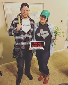 a man and woman standing in front of a map holding signs