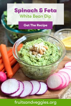 spinach and feta white bean dip in a bowl with sliced carrots on the side