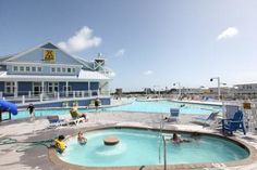 an outdoor swimming pool with people in it