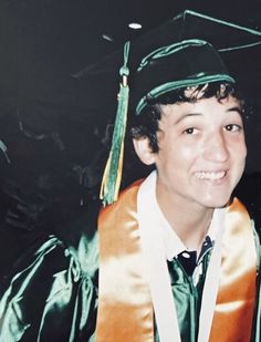 a young man wearing a graduation cap and gown