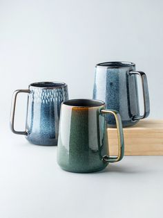 three coffee mugs sitting next to each other