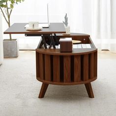 a wooden table with a laptop on it