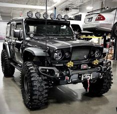 a black jeep is parked in a garage