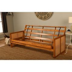 a wooden bench sitting on top of a rug in a living room next to a clock