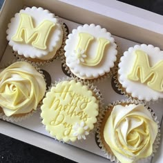 cupcakes in a box with frosting and the letters m, n, d