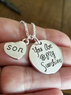 New Handmade Son, You Are My Sunshine Necklace The perfect gift for any boy mom. ♡ Silver plated engraved charm pendant reads 'You are my Sunshine' ♡ Silver plated son heart charm ♡ 18 inch Silver plated chain ♡ Lobster clasp closure ♡ Ships within 24 hours of purchase Monday-Saturday Memorial Necklace Son, Mother Son Necklace, Mom Daughter Jewelry, Son Necklace, Silver Chain Anklet, Jewelry For Mom, Mom Daughter Gifts, Large Dangle Earrings, Graduation Gifts For Daughter