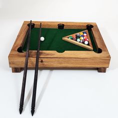 a pool table with two cues and a billiard's cues on it