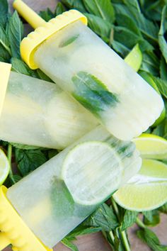 three popsicles with lime slices and mint on them