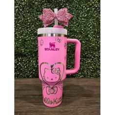 a pink starbucks cup with a bow on the top and hello kitty designs on it