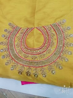 an embroidered yellow cloth with gold thread work