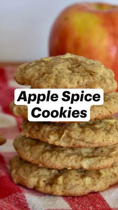 a stack of cookies with an apple in the background