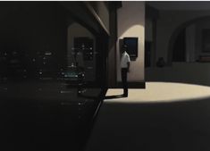 a man standing in an empty room at night